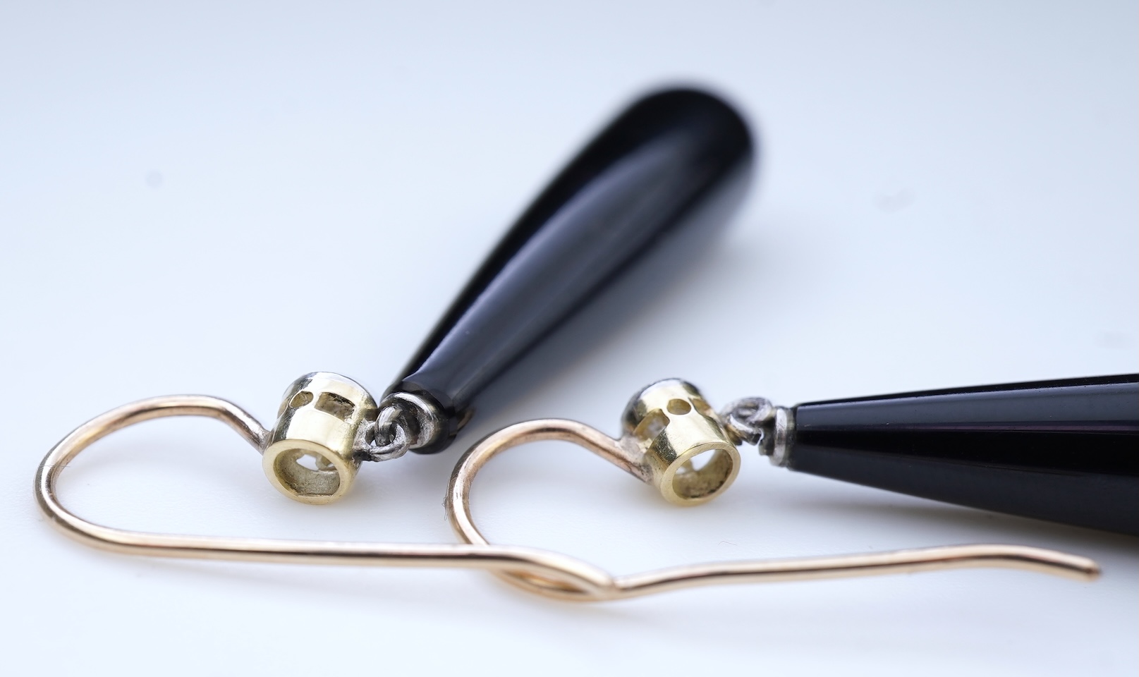 A pair of Art Deco onyx and diamond earrings, early 20th century
